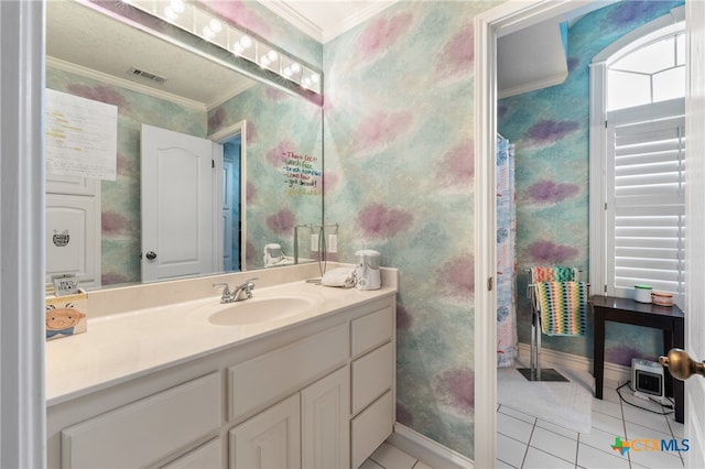 bathroom with tile patterned floors, vanity, and crown molding