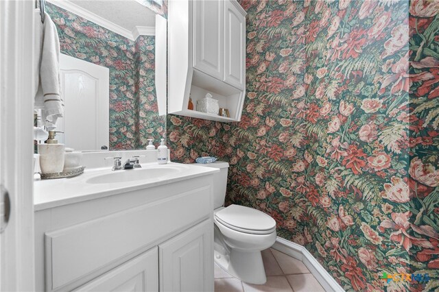 bathroom featuring tile patterned floors, vanity, toilet, and ornamental molding