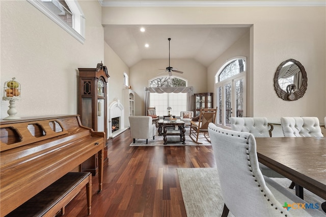 dining room featuring ceiling fan, crown molding, dark wood-type flooring, and vaulted ceiling