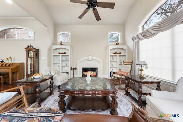 living room featuring ceiling fan and vaulted ceiling