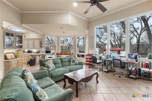 tiled living room featuring plenty of natural light, crown molding, and ceiling fan