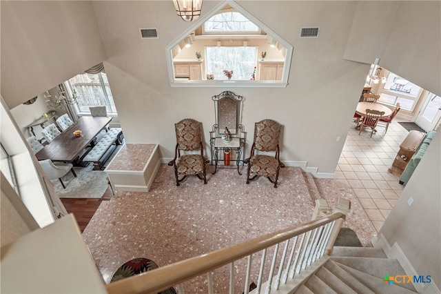 living area featuring light hardwood / wood-style floors and an inviting chandelier