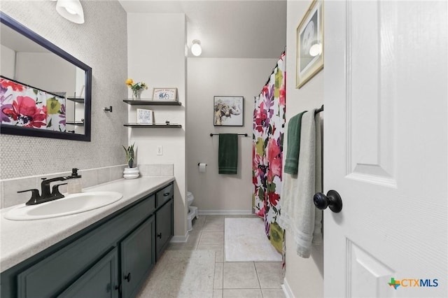 bathroom featuring vanity, tile patterned floors, and toilet