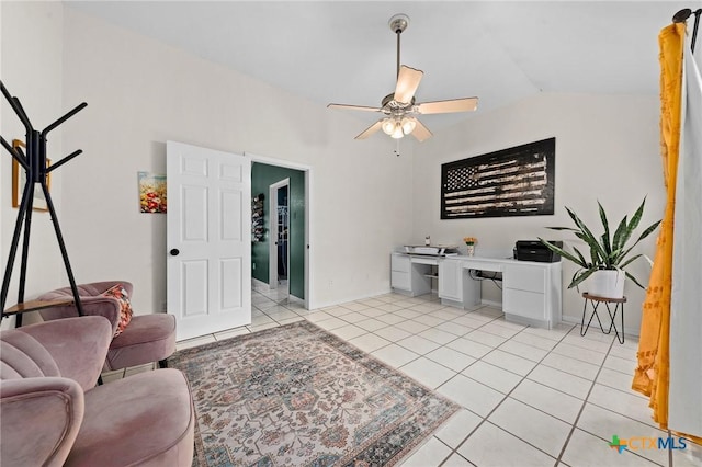 living room with lofted ceiling, ceiling fan, and light tile patterned flooring