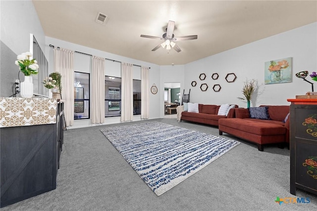 carpeted living room with ceiling fan