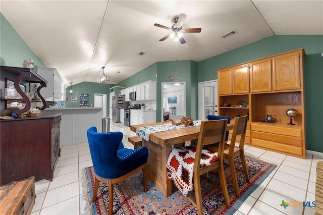 tiled dining area featuring ceiling fan and vaulted ceiling