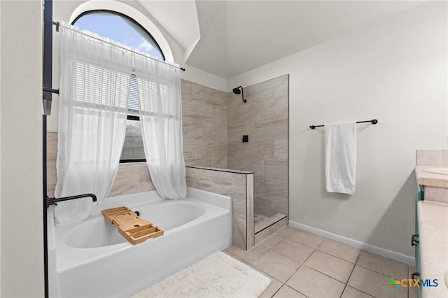 bathroom featuring independent shower and bath and tile patterned flooring