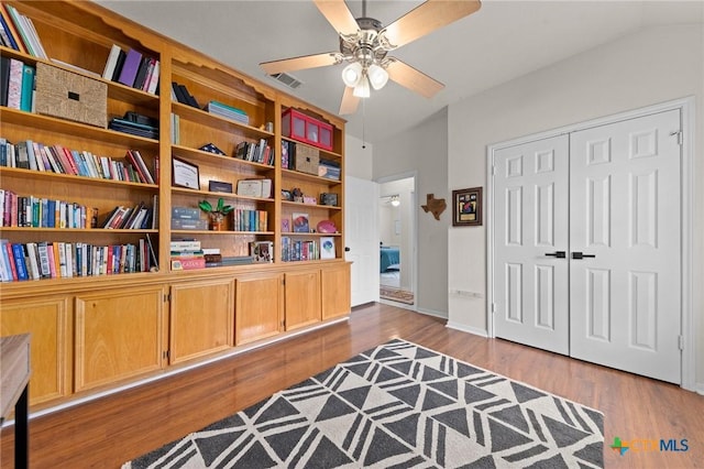 interior space featuring ceiling fan, lofted ceiling, and dark hardwood / wood-style flooring