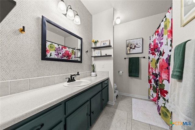 bathroom with vanity, toilet, and tile patterned flooring