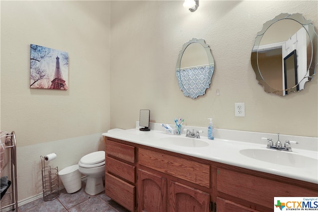 bathroom featuring toilet, vanity, and tile patterned floors