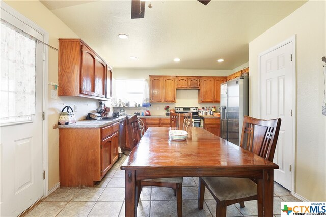 1074 Fm 3219, Harker Heights, TX 76548 - kitchen with stainless steel appliances, light countertops, brown cabinetry, light tile patterned floors, and recessed lighting