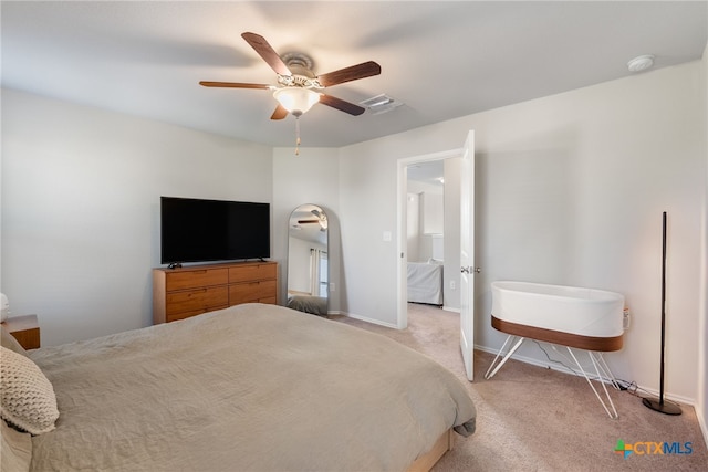 carpeted bedroom with ceiling fan, baseboards, and visible vents