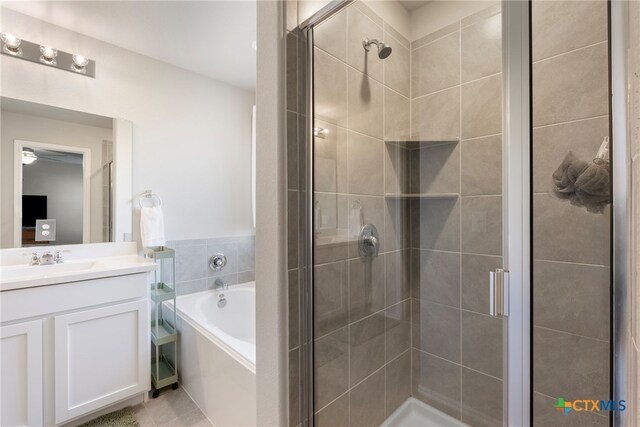 full bathroom featuring a shower stall, vanity, a bath, and a ceiling fan