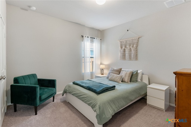 bedroom featuring light colored carpet, baseboards, and visible vents