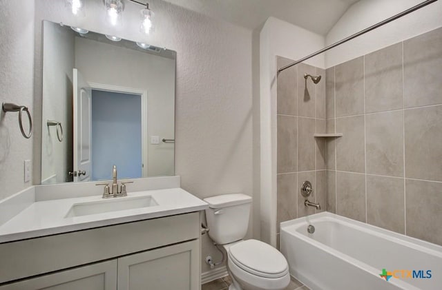 full bathroom featuring toilet, vanity, and tiled shower / bath