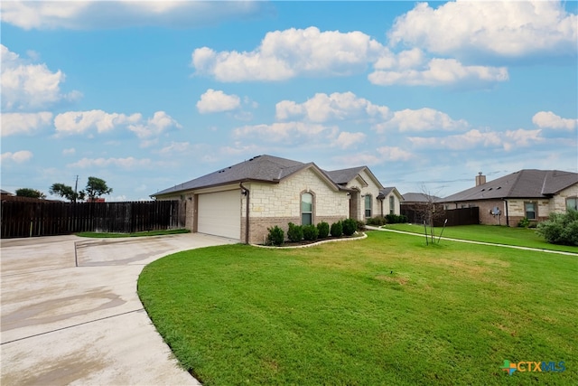 view of front facade featuring a garage and a front lawn