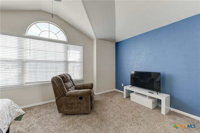 sitting room featuring light carpet and vaulted ceiling