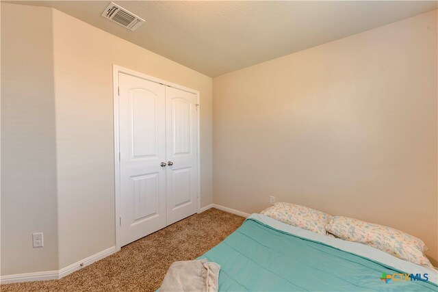 carpeted bedroom featuring a closet