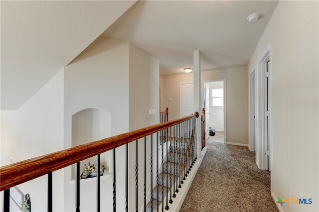 hallway featuring light carpet