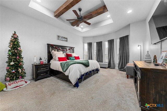 carpeted bedroom featuring ceiling fan and beamed ceiling