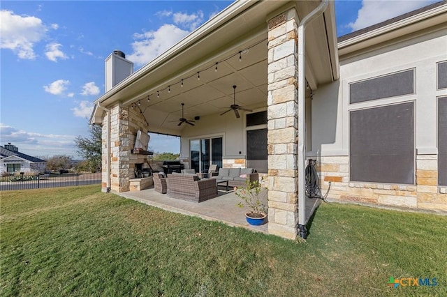 view of patio with an outdoor living space with a fireplace, area for grilling, and ceiling fan