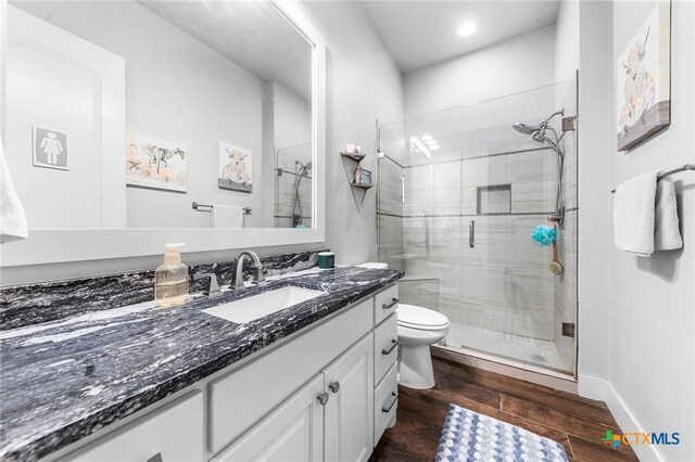 3004 Hester Way, Salado, TX 76571 - bathroom with vanity, a stall shower, wood finished floors, toilet, and recessed lighting