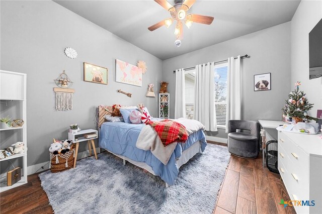 bedroom with ceiling fan and dark hardwood / wood-style floors