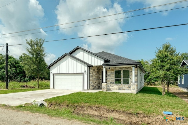 view of front of property with a front yard and a garage