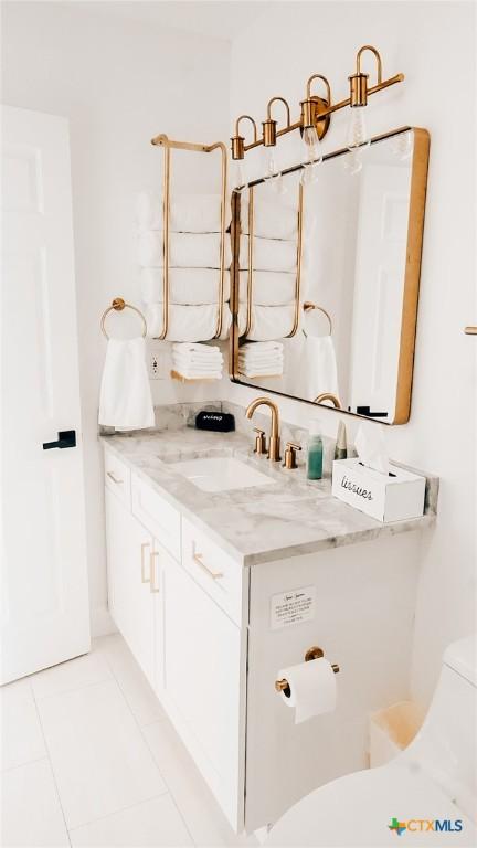 bathroom with vanity, toilet, and tile patterned floors