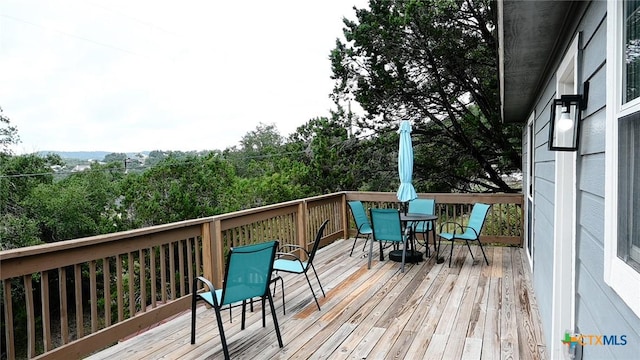 wooden deck with outdoor dining space