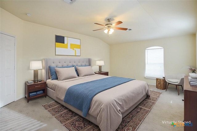 bedroom with vaulted ceiling, ceiling fan, and carpet flooring