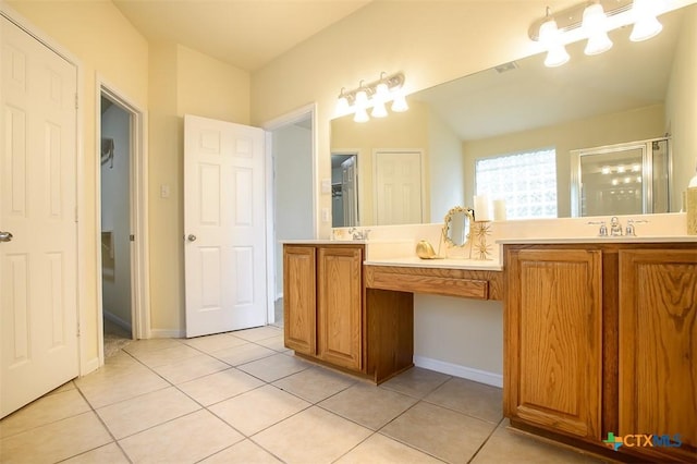 bathroom with tile patterned flooring, vanity, and a shower with shower door