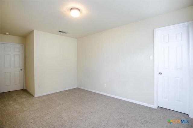 empty room with light colored carpet