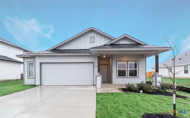 view of front of home with a garage and a front lawn