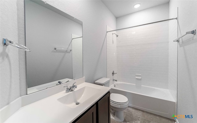 full bathroom with vanity, tiled shower / bath, and toilet