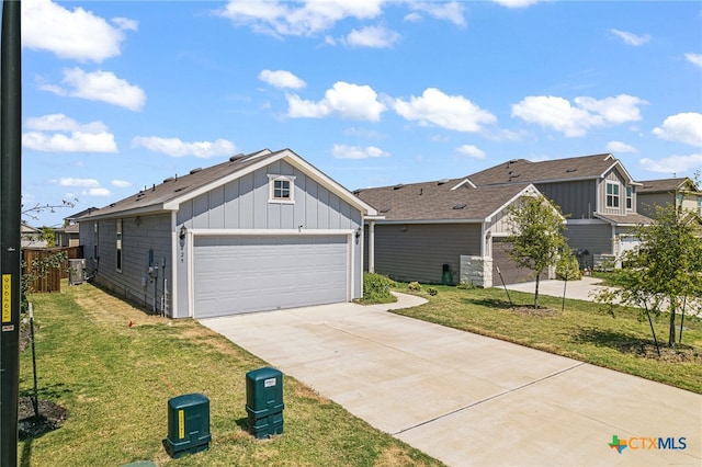 view of front of house with a garage and a front lawn