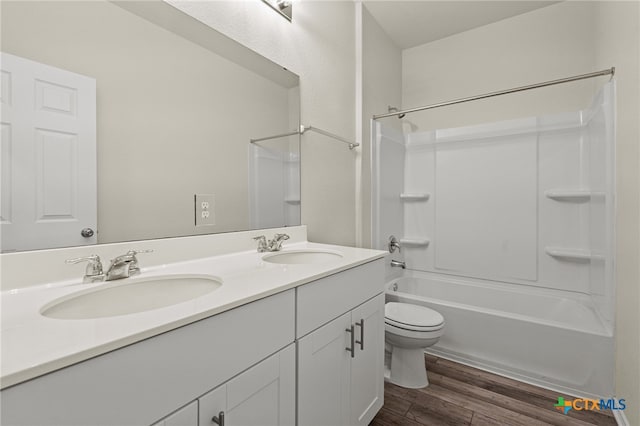 full bathroom with shower / bath combination, wood-type flooring, toilet, and vanity