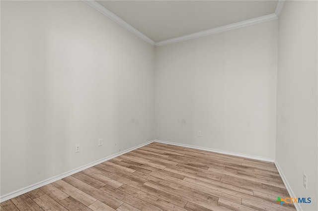 spare room featuring light hardwood / wood-style floors and crown molding