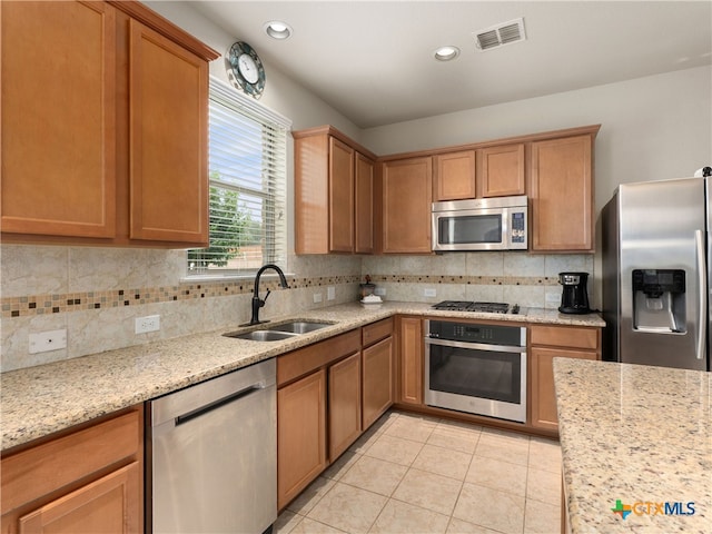 515 Secluded Grv, San Antonio, TX 78253 - kitchen with appliances with stainless steel finishes, a sink, backsplash, light tile patterned floors, and recessed lighting