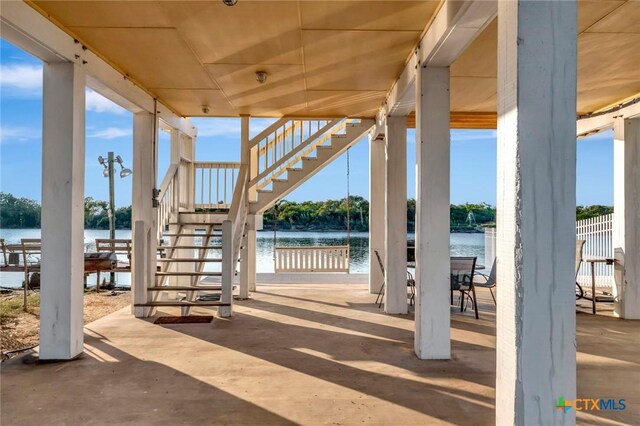 52 Fm 2031, Matagorda, TX 77457 - view of patio / terrace with stairway and a water view