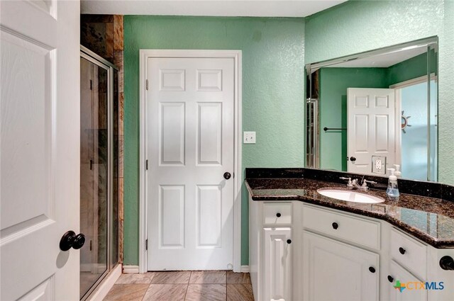 52 Fm 2031, Matagorda, TX 77457 - bathroom with a shower stall, vanity, and a textured wall