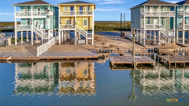 52 Fm 2031, Matagorda, TX 77457 - dock with a water view, a fenced backyard, a balcony, and stairway