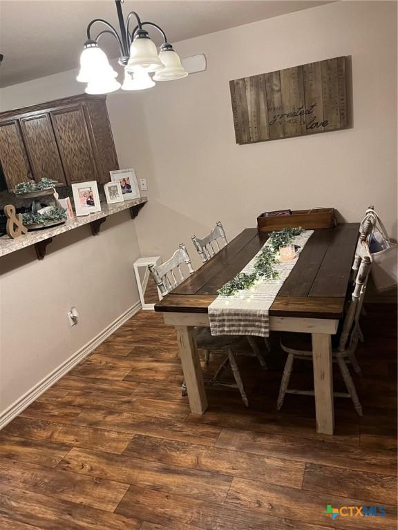 801AND803 S Live Oak St, Lampasas, TX 76550 - dining room with a chandelier and dark wood-style floors