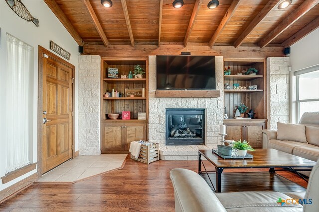 living room with hardwood / wood-style floors, beam ceiling, and wood ceiling