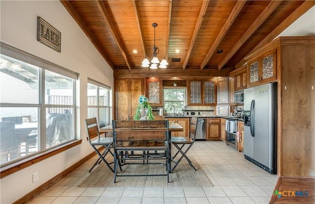 kitchen with wooden ceiling, light tile patterned flooring, appliances with stainless steel finishes, a notable chandelier, and pendant lighting