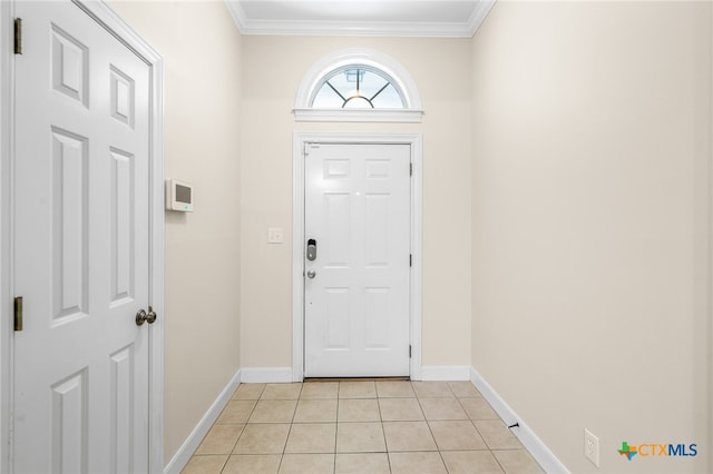 tiled foyer entrance featuring crown molding