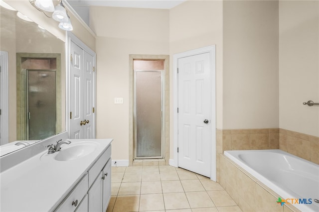 bathroom with independent shower and bath, tile patterned flooring, and vanity