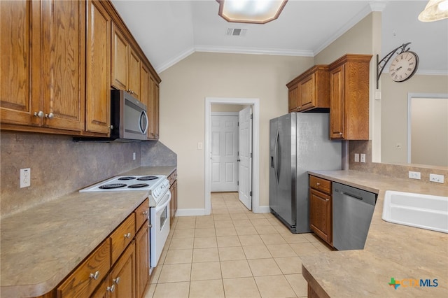 kitchen featuring light tile patterned flooring, stainless steel appliances, backsplash, sink, and lofted ceiling