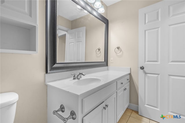 bathroom featuring vanity, tile patterned flooring, and toilet