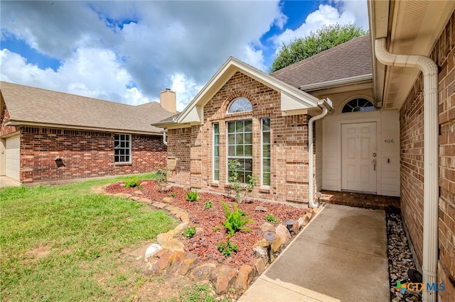 doorway to property featuring a lawn